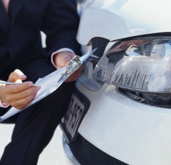 man inspecting vehicle