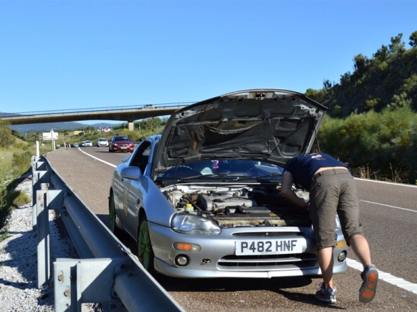 man fixing car